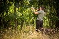 Woman hunter in the woods - taking the shot