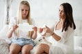 Woman hygene concept. Periods. Menstrual cycle. Mother explains daughter how to use hygiene pads and tampons. Woman and