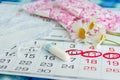 Woman hygiene protection , calendar close up.menstruation with cotton swabs , white daisies, Sanitary napkins on a light Royalty Free Stock Photo