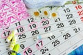 Woman hygiene protection , calendar close up.menstruation with cotton swabs , white daisies, Sanitary napkins on a light Royalty Free Stock Photo