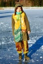 Woman on ice lake in beautiful ethno dress.