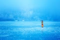 Woman on ice lake in beautiful ethno dress. Prayer for the lake.