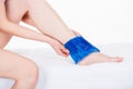 Woman with ice pack on ankle Royalty Free Stock Photo