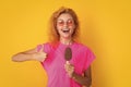 woman with icelolly ice cream in studio, thumb up. woman with icelolly ice cream