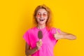 woman with icelolly ice cream in studio, thumb up. woman with icelolly ice cream