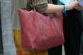 Woman with il Bisonte red bag before Emporio Armani fashion show, Milan Fashion Week street style Royalty Free Stock Photo