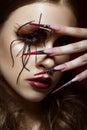 Woman in the image of spider with creative art makeup and long nails. Manicure design, beauty face. Royalty Free Stock Photo