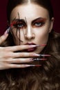 Woman in the image of spider with creative art makeup and long nails. Manicure design, beauty face. Royalty Free Stock Photo