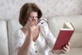 Woman with impaired vision reading a book through two glasses Royalty Free Stock Photo