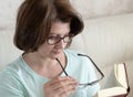 Woman with impaired vision reading a book through two glasses Royalty Free Stock Photo