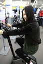 Woman in Indoor bycicle cycling in gym. Competition, caucasian. Royalty Free Stock Photo