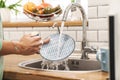 Woman indoors at home wash the dishes at the kitchen Royalty Free Stock Photo