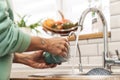 Woman indoors at home wash the dishes at the kitchen Royalty Free Stock Photo