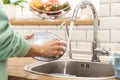 Woman indoors at home wash the dishes at the kitchen Royalty Free Stock Photo