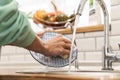 Woman indoors at home wash the dishes at the kitchen Royalty Free Stock Photo