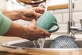 Woman indoors at home wash the dishes at the kitchen Royalty Free Stock Photo