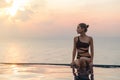 Woman at the infinity pool on sunset Royalty Free Stock Photo