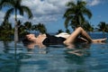 Woman in infinity swimming pool. Sexy girl enjoying tropical infinity pool with a jungle view in Hawaii. Royalty Free Stock Photo