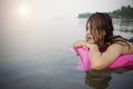 Woman on inflatable swimming pool bed enjoying sun tanning. Royalty Free Stock Photo