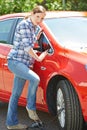 Woman Inflating Car Tyre With Foot Pump Royalty Free Stock Photo