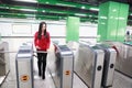 Woman insert ticket to ticket entrance train station