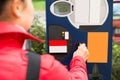 Woman Inserting Coin In Parking Meter