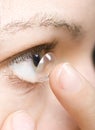 Woman inserting a contact lens into the eye Royalty Free Stock Photo