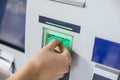 Woman inserting a credit card in ATM bank machine to transfer money or withdraw. Finance customer and banking service concept Royalty Free Stock Photo