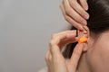 Woman Inserting Earplug for Hearing Protection Royalty Free Stock Photo