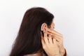 Woman inserting her hearing aid Royalty Free Stock Photo