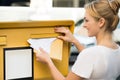 Woman Inserting Letter In Mailbox Royalty Free Stock Photo