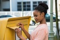Woman Inserting Letter In Mailbox Royalty Free Stock Photo