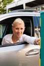 Woman is inserting parking ticket into barrier Royalty Free Stock Photo