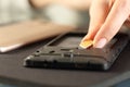 Woman inserting sim card on smart phone on a desk Royalty Free Stock Photo