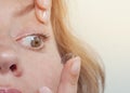 Woman inserts a contact lens into the eye. Close-up, domestic scene. Optics, Vision, Optical Instruments Royalty Free Stock Photo
