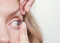 Woman inserts a contact lens into the eye Royalty Free Stock Photo