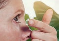 Woman inserts a contact lens into the eye Royalty Free Stock Photo