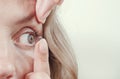 Woman inserts a contact lens into the eye Royalty Free Stock Photo