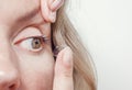 Woman inserts a contact lens into the eye Royalty Free Stock Photo