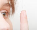 Woman inserts contact lens in eye Royalty Free Stock Photo