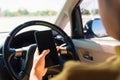 Woman inside a car and using a hand holding mobile smartphone Royalty Free Stock Photo