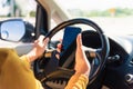 Woman inside a car and using a hand holding mobile smartphone Royalty Free Stock Photo