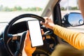 Woman inside a car and using a hand holding mobile smartphone Royalty Free Stock Photo
