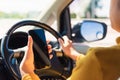 Woman inside a car and using a hand holding mobile smartphone Royalty Free Stock Photo