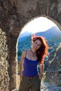 Woman inside a tunnel with mountains behind her. Royalty Free Stock Photo