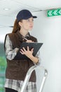 Woman inspecting exit sign Royalty Free Stock Photo