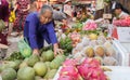 Woman inspecting fruit on a market in Hoi An, Vietnam