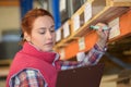 Woman inspector doing inventory in warehouse