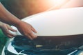 Woman inspects the damage of a damaged car on the road Royalty Free Stock Photo