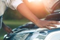 Woman inspects the damage of a damaged car on the road Royalty Free Stock Photo